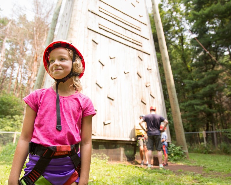 Girl in front a climbing tower