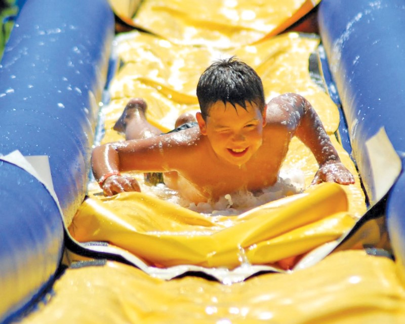 Boy going down a water slide