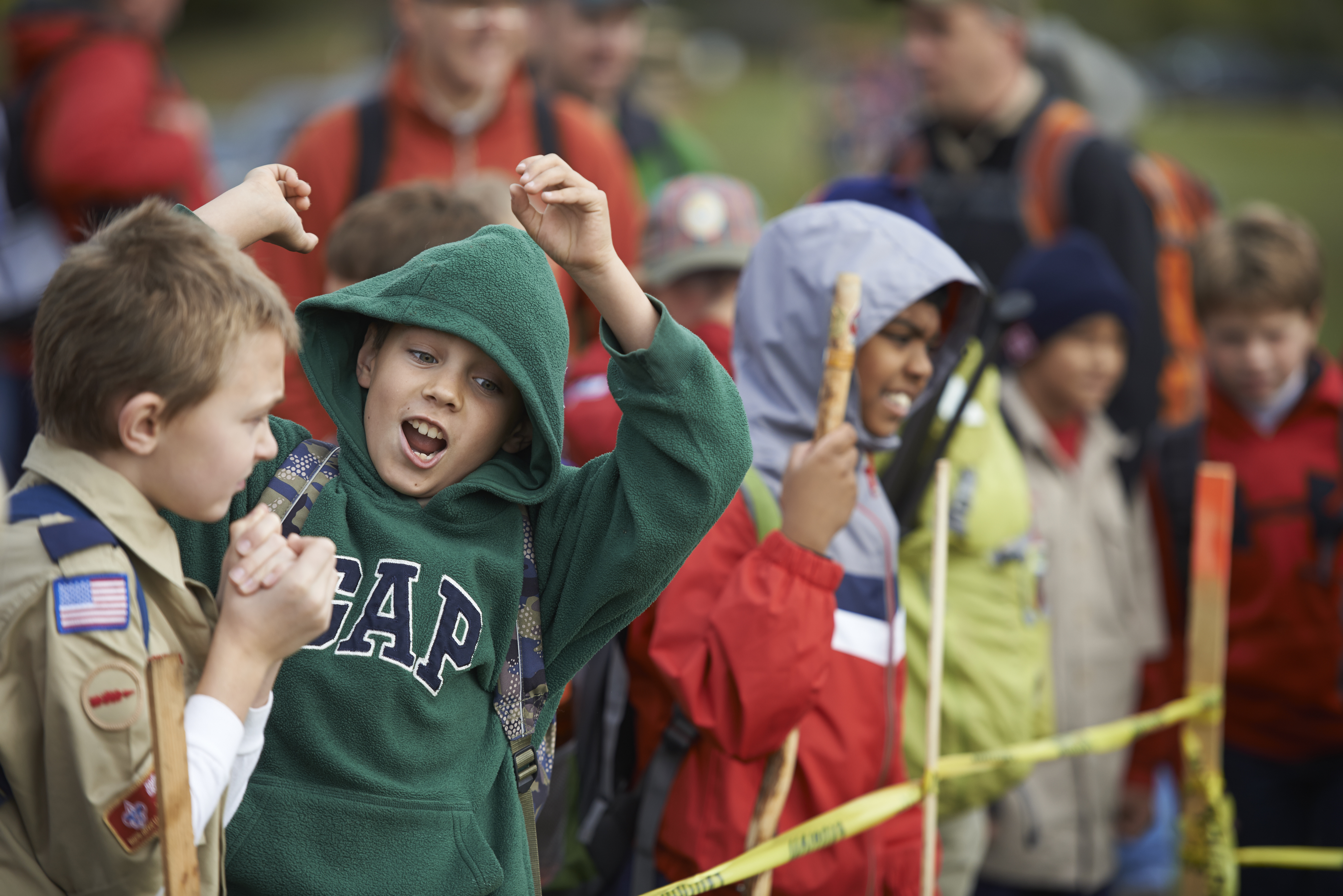 A group of Scouts cheering behind yellow tape A group of Scouts cheering behind yellow tape