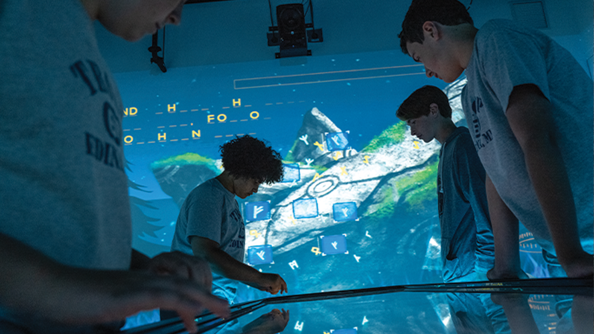 A group of youth working on a screen in the Leadership Lab